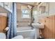 Bathroom showcasing a combined bathtub and shower with tiled walls and updated fixtures at 2022 S Clay St, Denver, CO 80219