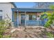 Inviting covered front porch with blue railings, leading to the home's entrance and front door at 2022 S Clay St, Denver, CO 80219