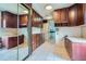 Kitchen featuring ample cabinet space, a mirror wall, tile flooring, and natural light at 2022 S Clay St, Denver, CO 80219