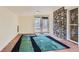 Living room with tile floor, a stone wall accent, and sliding glass doors to the outside at 2022 S Clay St, Denver, CO 80219
