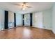 Cozy living room with vintage-style flooring, a ceiling fan, and ample natural light at 2022 S Clay St, Denver, CO 80219
