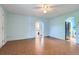 Open living room with original hardwood floors, blue walls, and arched doorways leading to other rooms at 2022 S Clay St, Denver, CO 80219