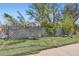 Front yard features a decorative lattice fence and lush green turf, providing a charming curb appeal at 2022 S Clay St, Denver, CO 80219