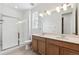 Updated bathroom with double vanity and a shower at 144 Wooten Ave, Brighton, CO 80601