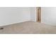 Spacious carpeted bedroom with access to a bathroom at 144 Wooten Ave, Brighton, CO 80601