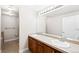 Bathroom with double sinks, tile flooring, a large mirror, and a shower-tub combination at 9019 E Panorama Cir # D211, Centennial, CO 80112