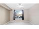 Well-lit bedroom with neutral walls, plush carpeting, a ceiling fan, and a large window at 9019 E Panorama Cir # D211, Centennial, CO 80112