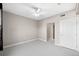 Bright bedroom featuring soft carpeting, neutral walls, a ceiling fan, and a doorway to an adjacent room at 9019 E Panorama Cir # D211, Centennial, CO 80112