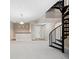 Spacious living room featuring a spiral staircase, plush carpeting, and recessed lighting at 9019 E Panorama Cir # D211, Centennial, CO 80112