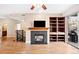 Bright living room with a fireplace, built-in shelving, hardwood floors, and access to a balcony at 9019 E Panorama Cir # D211, Centennial, CO 80112