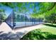 Outdoor basketball court behind fence with attractive landscaping and nearby sidewalk at 2902 W Long Cir # B, Littleton, CO 80120
