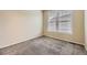A bright bedroom with wall-to-wall carpet and two windows at 2902 W Long Cir # B, Littleton, CO 80120
