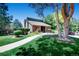 Community center with brick facade, walkway, mature trees, and bench seating at 2902 W Long Cir # B, Littleton, CO 80120