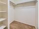 Walk-in closet with built-in shelves and custom wood flooring at 2902 W Long Cir # B, Littleton, CO 80120