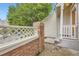 Exterior brick and rail near the front door with lovely mature landscaping at 2902 W Long Cir # B, Littleton, CO 80120