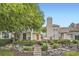 Charming home featuring stone accents, a well-manicured lawn, mature landscaping, and a welcoming front entrance at 2902 W Long Cir # B, Littleton, CO 80120