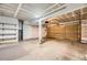 Spacious unfinished garage with concrete floors, overhead door, and utility shelving at 2902 W Long Cir # B, Littleton, CO 80120