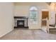 Comfortable living room showcasing a fireplace, carpet, and entry staircase at 2902 W Long Cir # B, Littleton, CO 80120