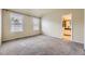 Main bedroom featuring two windows, wall-to-wall carpet, and an en-suite bathroom at 2902 W Long Cir # B, Littleton, CO 80120