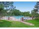 Community pool surrounded by trees and plenty of seating and umbrellas at 2902 W Long Cir # B, Littleton, CO 80120