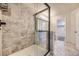 Modern shower with mosaic tile surround, glass door, and sleek fixtures at 2902 W Long Cir # B, Littleton, CO 80120