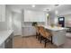 Modern kitchen with stainless steel appliances and white and gray cabinets, an island with seating at 9021 Raleigh St, Westminster, CO 80031