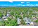Scenic aerial view of a neighborhood featuring lush trees, diverse homes, and stunning mountain views at 5610 Brentwood St, Arvada, CO 80002