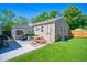 Backyard features an artificial grass, a patio with seating, outdoor furniture, grill, and an outdoor dining table at 5610 Brentwood St, Arvada, CO 80002
