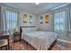 Inviting bedroom features a comfortable bed, colorful rug, and artistic wall decor, creating a relaxing atmosphere at 5610 Brentwood St, Arvada, CO 80002