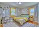 Serene bedroom with a desk, vanity, natural light, hardwood floors, and soft green accents at 5610 Brentwood St, Arvada, CO 80002