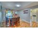 Bright dining room with a wood table, seating for six, and hardwood floors at 5610 Brentwood St, Arvada, CO 80002