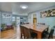 Open-concept dining room featuring hardwood floors and seamless flow to other living areas at 5610 Brentwood St, Arvada, CO 80002