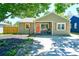Charming single-story home with a welcoming front porch, orange door, and well-maintained landscaping at 5610 Brentwood St, Arvada, CO 80002