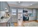 Updated kitchen with grey cabinets, granite countertops, stainless steel appliances, and a modern design at 5610 Brentwood St, Arvada, CO 80002