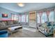 Inviting living room featuring a comfortable sofa, stylish armchair, and ample natural light at 5610 Brentwood St, Arvada, CO 80002