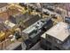 Aerial view of the home with rooftop deck, set amongst neighboring houses and a tree-lined street at 4426 Utica St, Denver, CO 80212