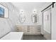 Stylish bathroom with dual vanities, marble countertops, unique mirrors, and modern fixtures at 4426 Utica St, Denver, CO 80212