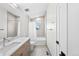 Well-lit bathroom featuring a shower-tub combo, vanity with marble top, and modern fixtures at 4426 Utica St, Denver, CO 80212