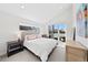 Bright bedroom with vaulted ceiling, access to balcony, neutral tones, and modern furnishings at 4426 Utica St, Denver, CO 80212