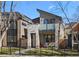 Contemporary home with stone accents, balcony, small front yard, and modern architectural details at 4426 Utica St, Denver, CO 80212