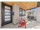 Inviting front porch featuring a modern glass door and wood ceiling at 4426 Utica St, Denver, CO 80212