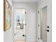 Bright hallway with white walls and trim, showcasing a glimpse into a bedroom with a mountain view at 4426 Utica St, Denver, CO 80212