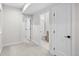 Hallway featuring neutral carpet and doors leading to a bedroom and bathroom at 4426 Utica St, Denver, CO 80212