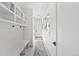 Hallway area with built in shelving and bench with a patterned rug on the floor at 4426 Utica St, Denver, CO 80212