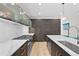 Close-up of a modern kitchen with stainless steel appliances, white countertops, and sleek dark cabinetry at 4426 Utica St, Denver, CO 80212