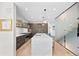 Open-concept kitchen with a marble island, pendant lighting, and modern appliances at 4426 Utica St, Denver, CO 80212