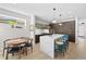 Bright kitchen with marble countertop island, stylish stools, modern lighting, and hardwood floors at 4426 Utica St, Denver, CO 80212