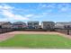 Large backyard with rock landscaping, artificial turf, and a wooden fence at 26818 E 1St Pl, Aurora, CO 80018