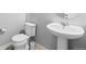 Clean, half bathroom features a pedestal sink and toilet at 26818 E 1St Pl, Aurora, CO 80018
