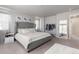 Bedroom showcasing a large tufted bed and a decorative full-length mirror at 26818 E 1St Pl, Aurora, CO 80018